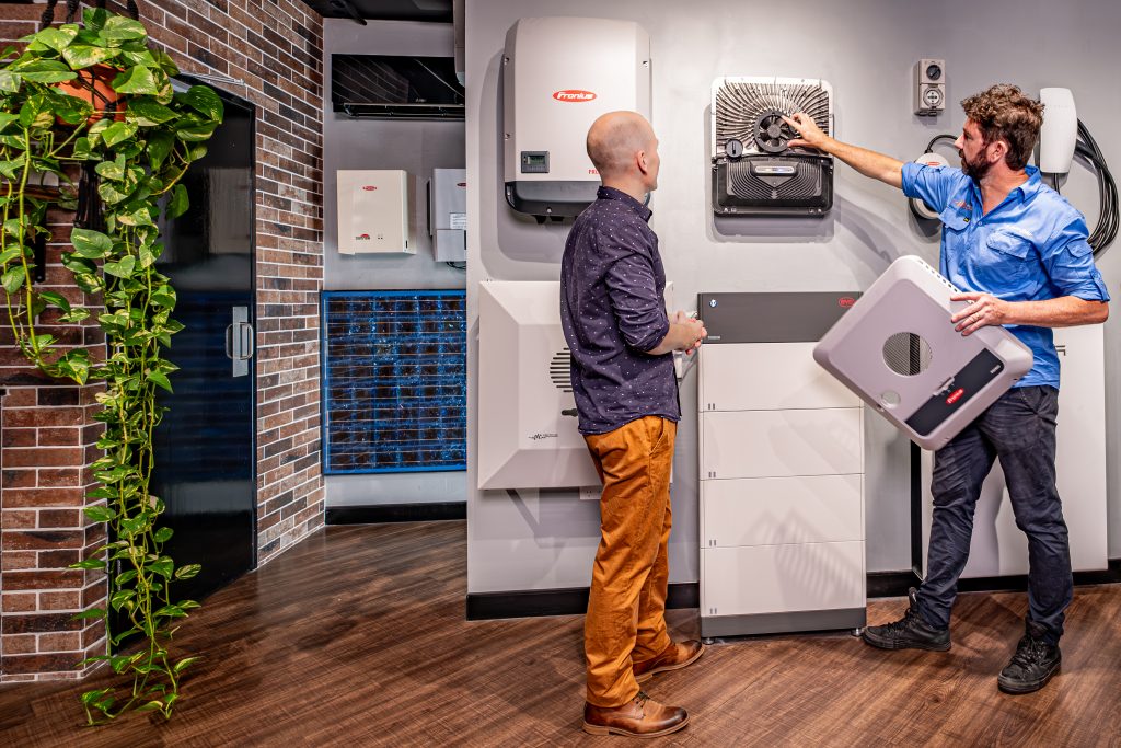 electrician showing customer fronius inverter